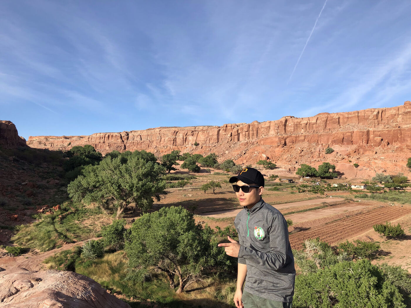 Sher in Celtics gear and a Pirates cap, canyon backdrop
